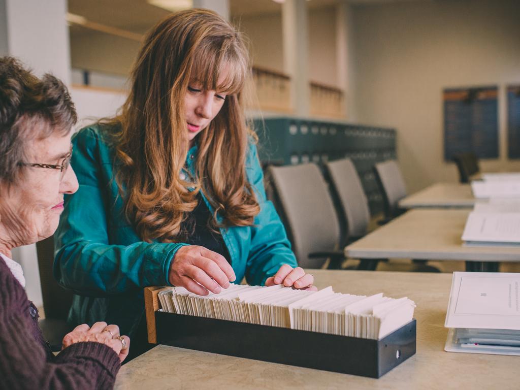 People looking at card catalog